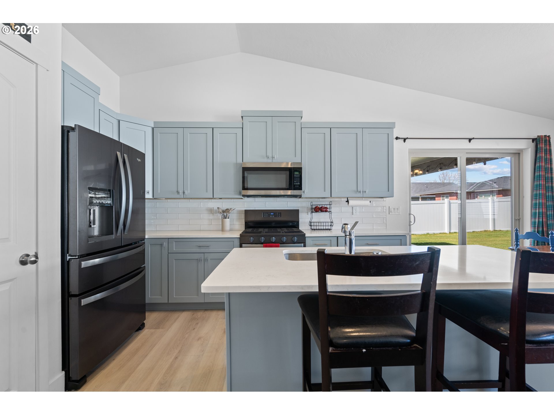 306 Sage Street Boardman, OR 97818 - Photo 3 of 24 a kitchen with a table chairs refrigerator and microwave