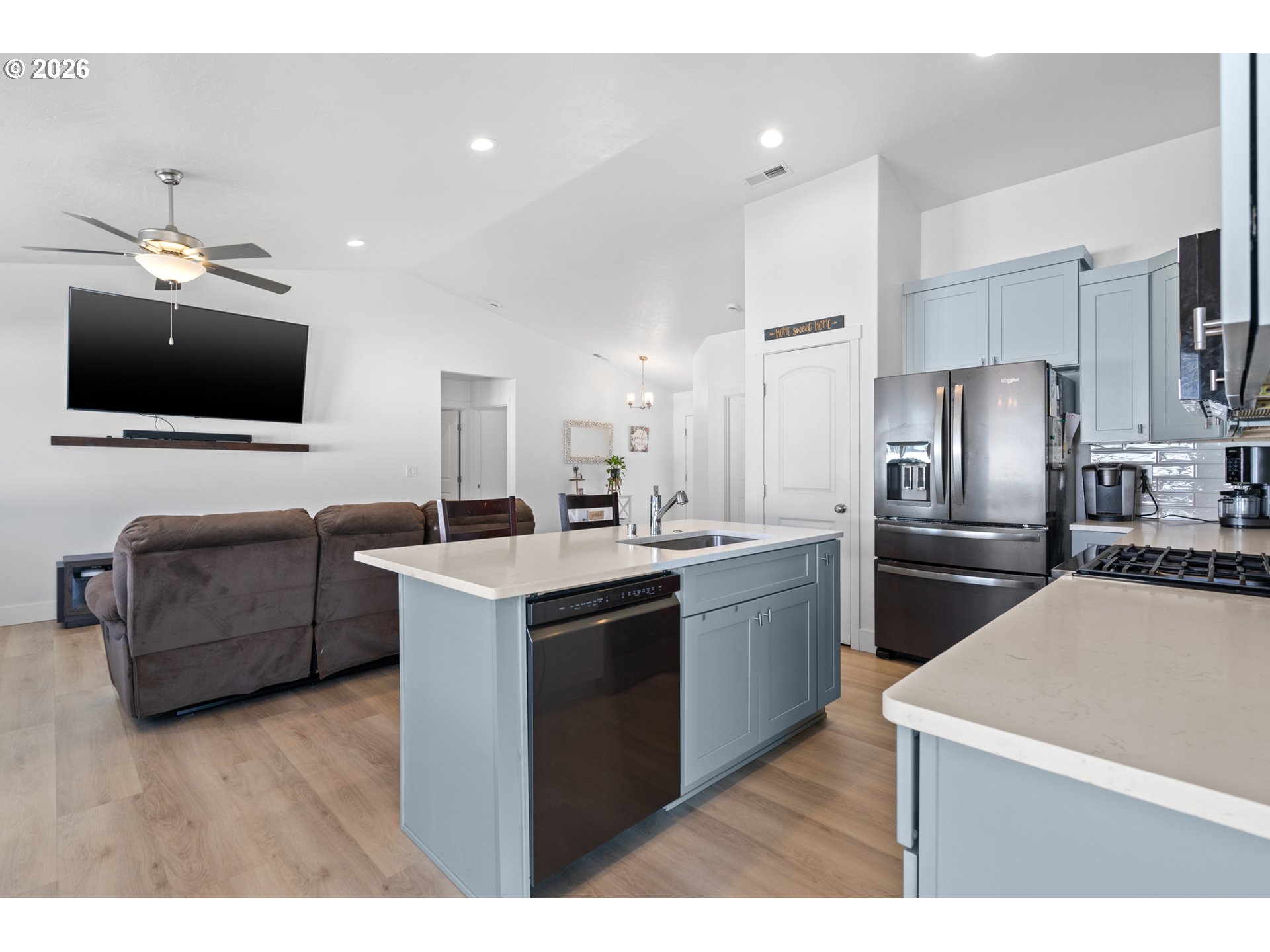 306 Sage Street Boardman, OR 97818 - Photo 6 of 24 a kitchen with a refrigerator sink and wooden floor
