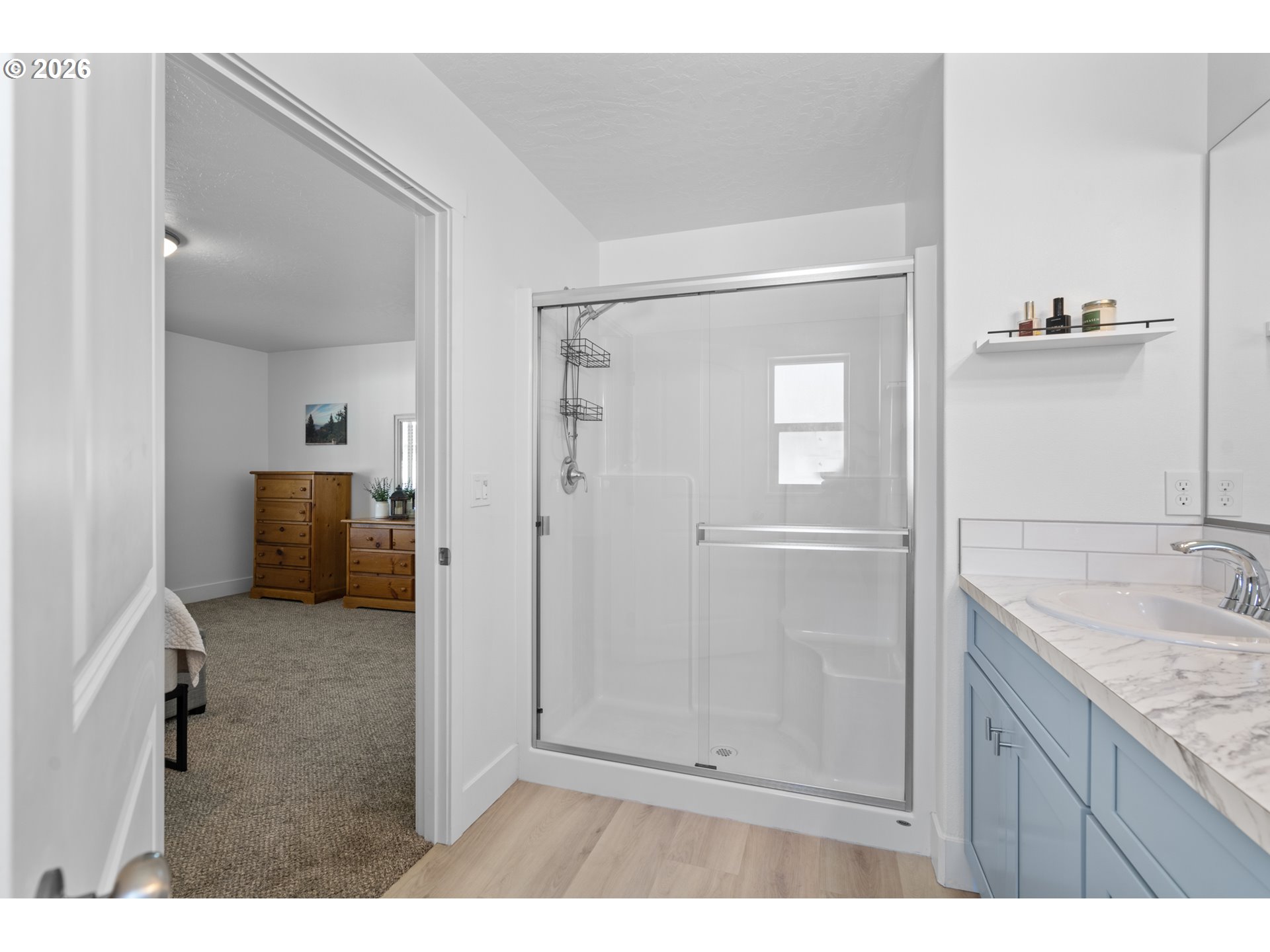 306 Sage Street Boardman, OR 97818 - Photo 10 of 24 a bathroom with a granite countertop sink a mirror and shower