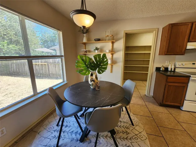 a dining room with furniture and window
