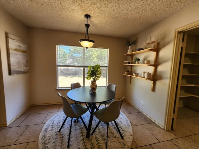 a view of a dining room with furniture and chandelier