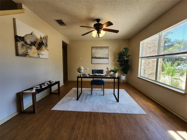 a living room with furniture a window and a chandelier