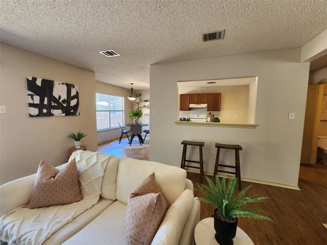 a bedroom with a large bed and a potted plant