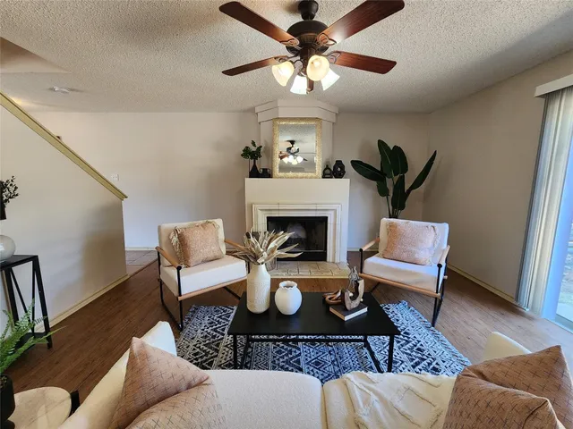 a living room with furniture a fireplace and a chandelier