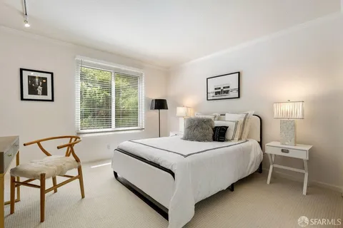 a bedroom with a bed and a chair