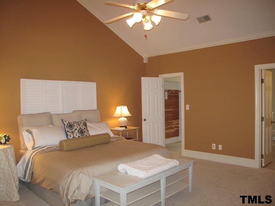 2812 Hawtree Drive Raleigh, NC 27613 - Photo 12 of 22 a bedroom with a bed and a chandelier
