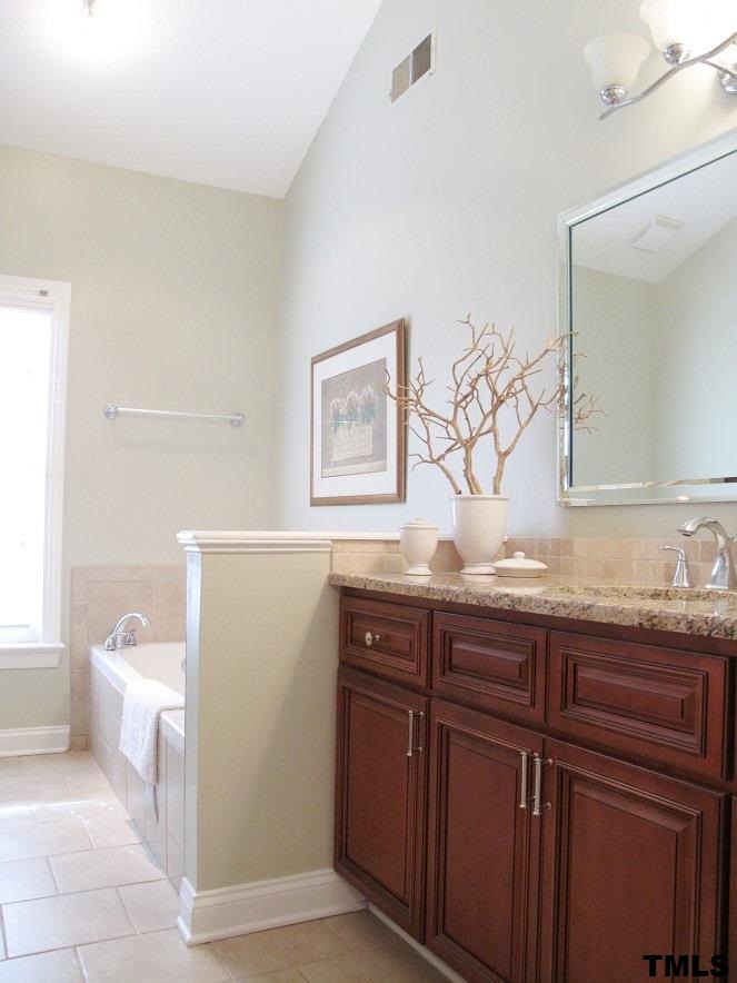 2812 Hawtree Drive Raleigh, NC 27613 - Photo 14 of 22 a bathroom with a granite countertop sink and a mirror