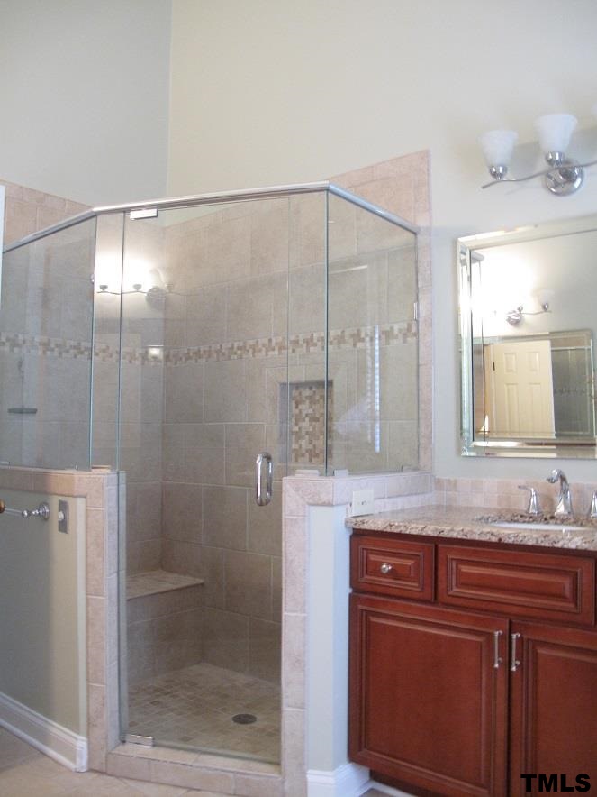 2812 Hawtree Drive Raleigh, NC 27613 - Photo 15 of 22 a bathroom with a granite countertop shower sink and mirror