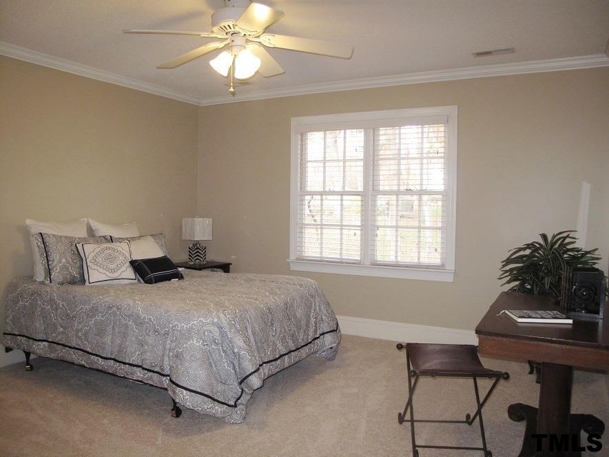 2812 Hawtree Drive Raleigh, NC 27613 - Photo 17 of 22 a bedroom with a bed table chair and a window