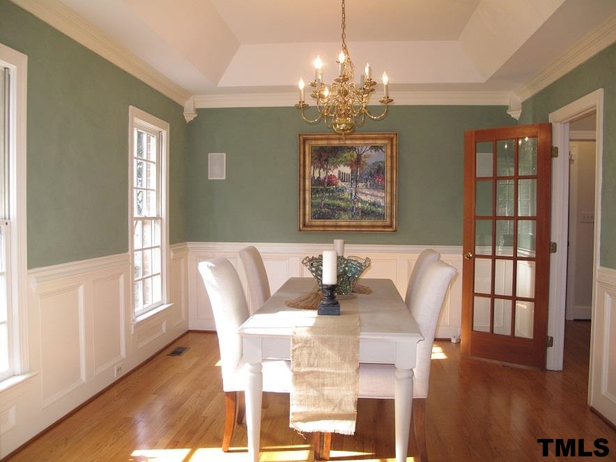 2812 Hawtree Drive Raleigh, NC 27613 - Photo 4 of 22 a view of a dining room with furniture a chandelier and wooden floor