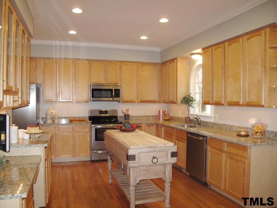 2812 Hawtree Drive Raleigh, NC 27613 - Photo 9 of 22 a kitchen with a sink a counter top space appliances and cabinets