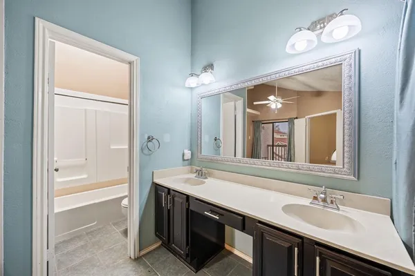 a bathroom with a sink a vanity and a mirror