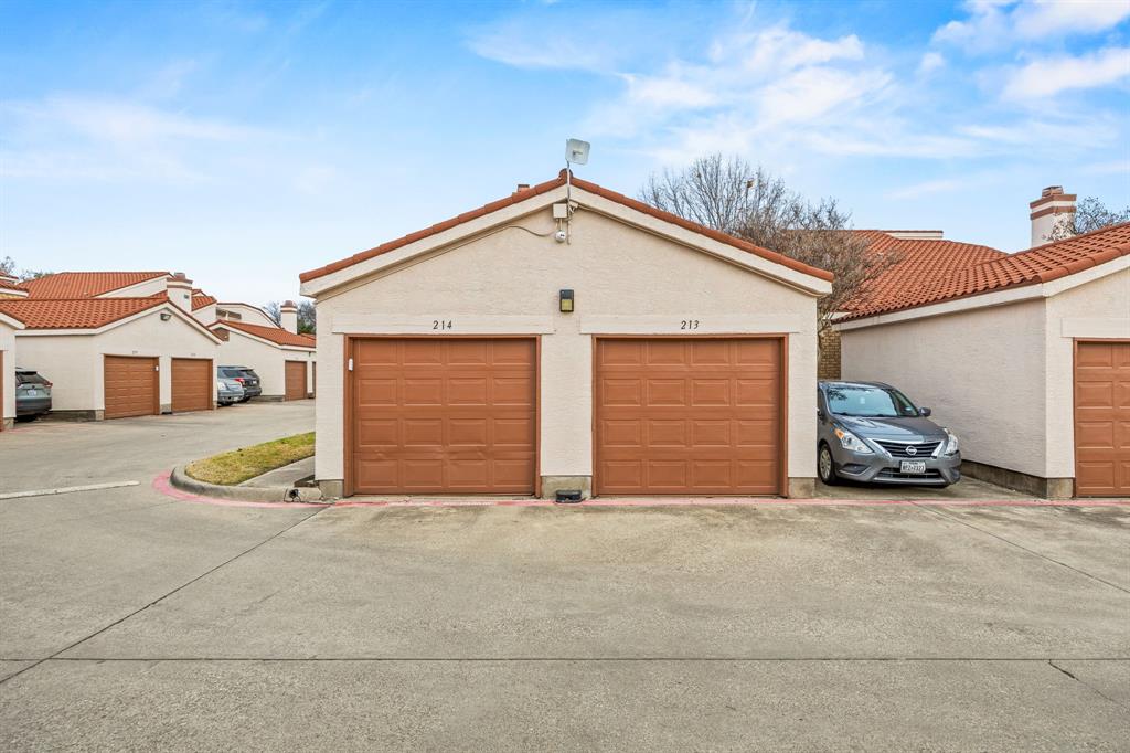 559 Ranch Trail, Unit 213 Irving, TX 75063 - Photo 18 of 18 a view of a house with garage and a car parked in it
