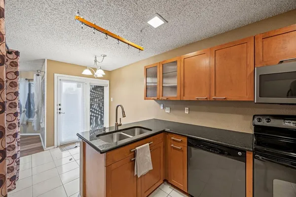 a kitchen with stainless steel appliances a stove sink and cabinets