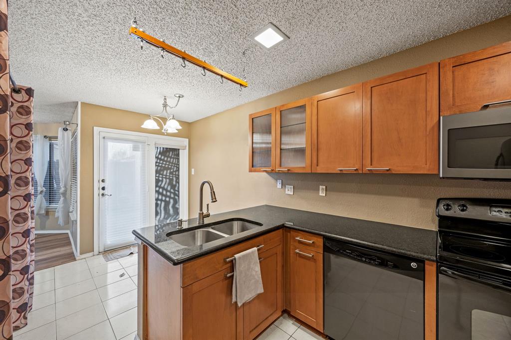 559 Ranch Trail, Unit 213 Irving, TX 75063 - Photo 3 of 18 a kitchen with stainless steel appliances a stove sink and cabinets