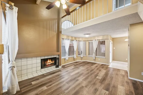 a view of an empty room with a fireplace and a window