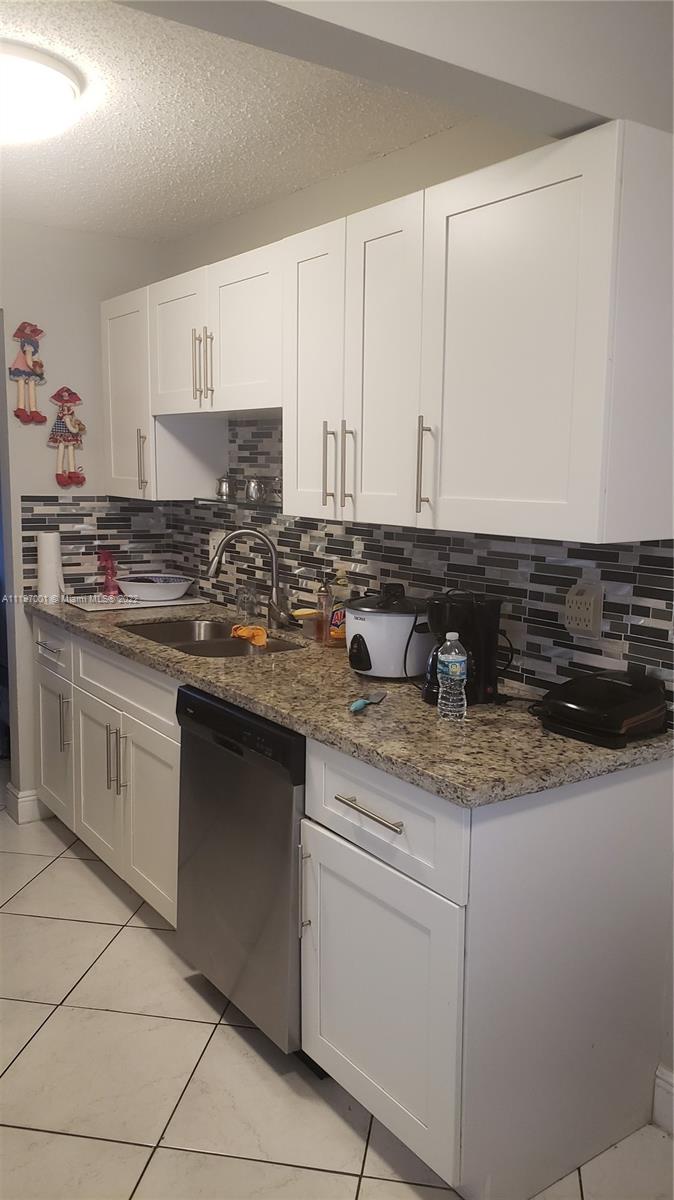 3120 North Pine Island Road, Unit 203 Sunrise, FL 33351 - Photo 3 of 8 a kitchen with stainless steel appliances granite countertop a sink stove and cabinets