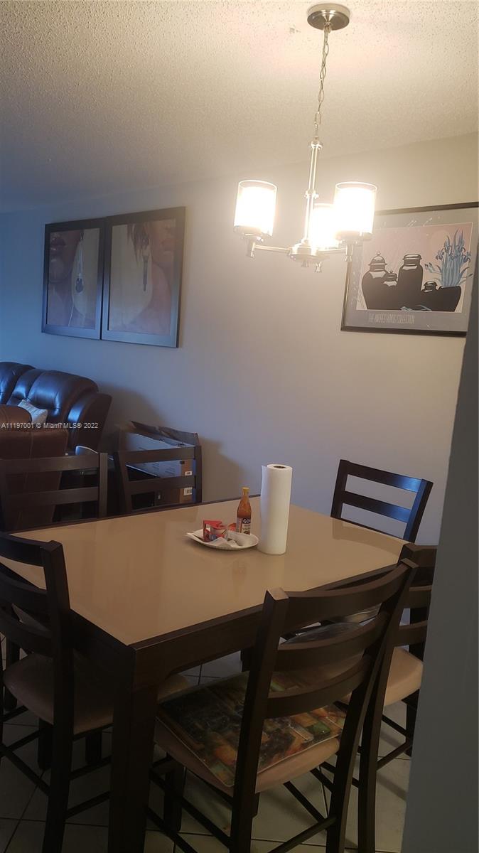 3120 North Pine Island Road, Unit 203 Sunrise, FL 33351 - Photo 6 of 8 a view of a dining room with furniture