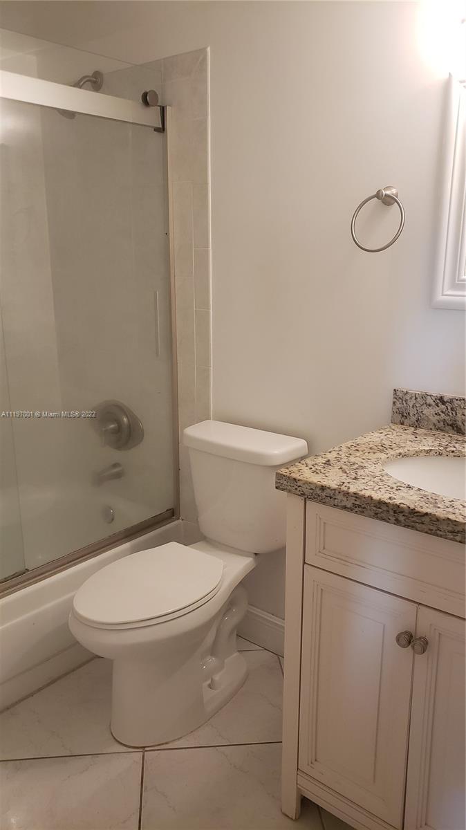 3120 North Pine Island Road, Unit 203 Sunrise, FL 33351 - Photo 8 of 8 a white toilet sitting next to a bathroom sink