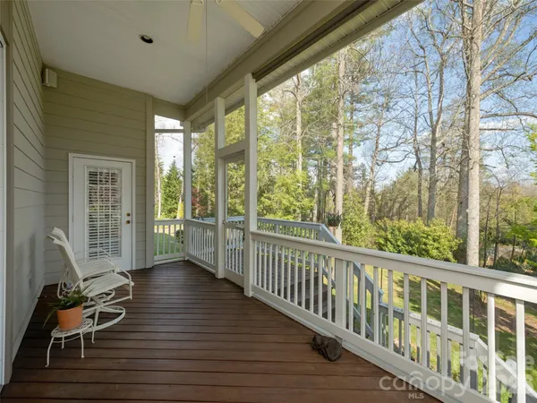 a view of a room with wooden floor and furniture