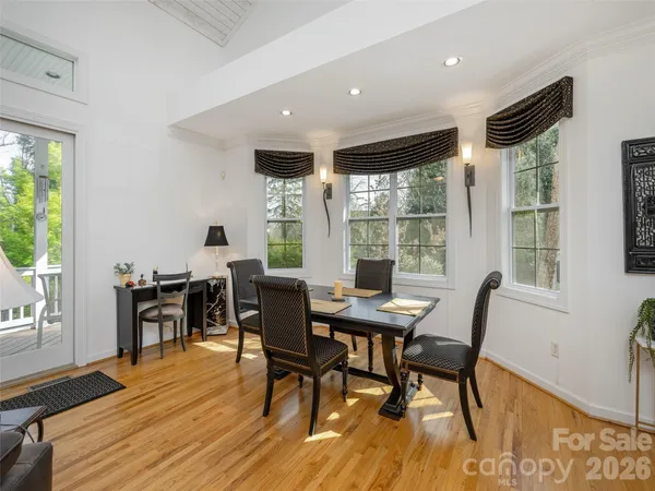 a view of a dining room with furniture window and wooden floor