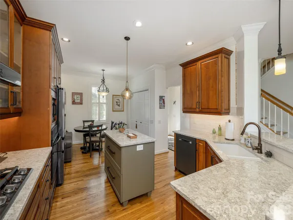 a kitchen with sink a counter and cabinets
