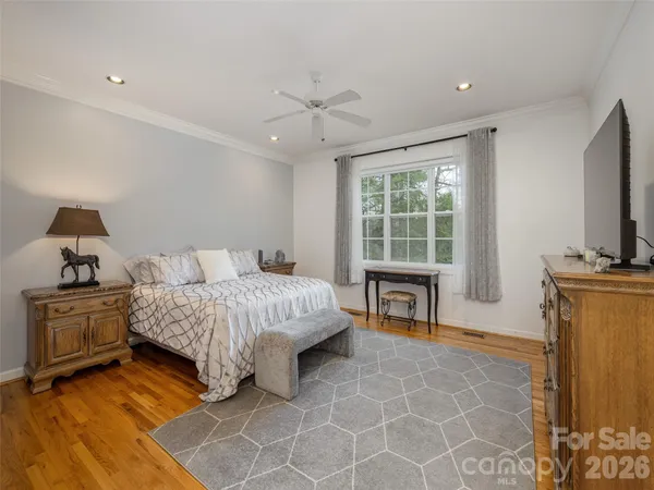 a bedroom with a bed and a television