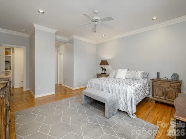 a bedroom with a bed and ceiling fan