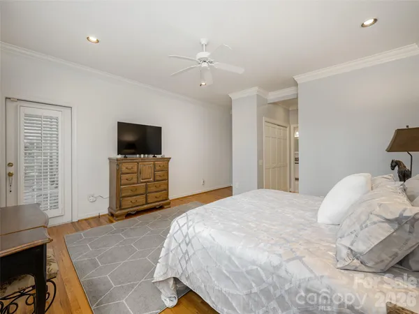 a bedroom with a bed and a television