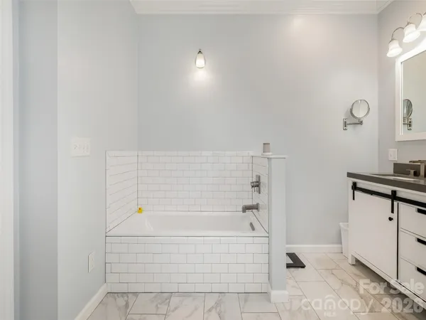 a bathroom with a bathtub and shower