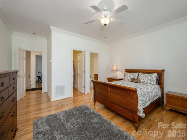 a spacious bedroom with a bed and a chandelier