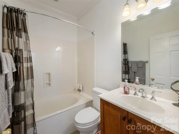 a bathroom with a sink a toilet a tub and shower