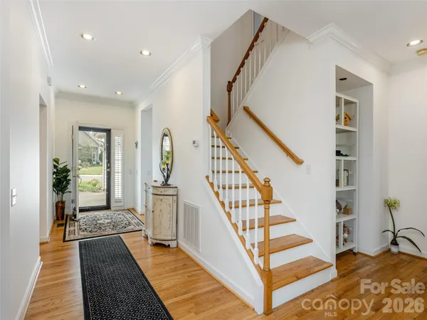 a view of entryway and hall with wooden floor