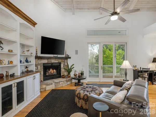 a living room with furniture fireplace and flat screen tv