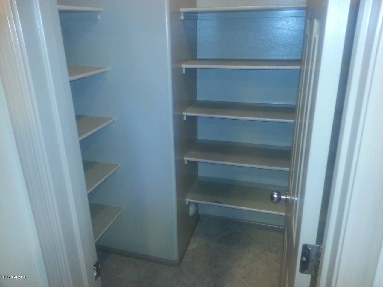 44395 Cypress Lane Maricopa, AZ 85138 - Photo 9 of 20 a view of walk in closet with empty racks