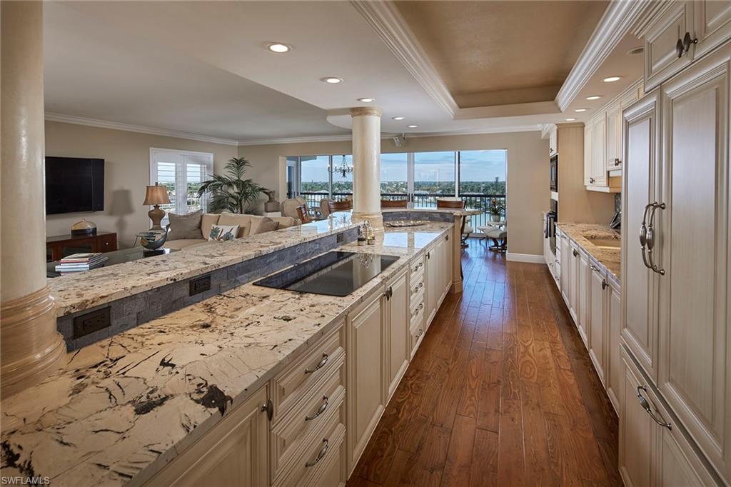 a open kitchen with stainless steel appliances granite countertop a lot of counter space and wooden floors