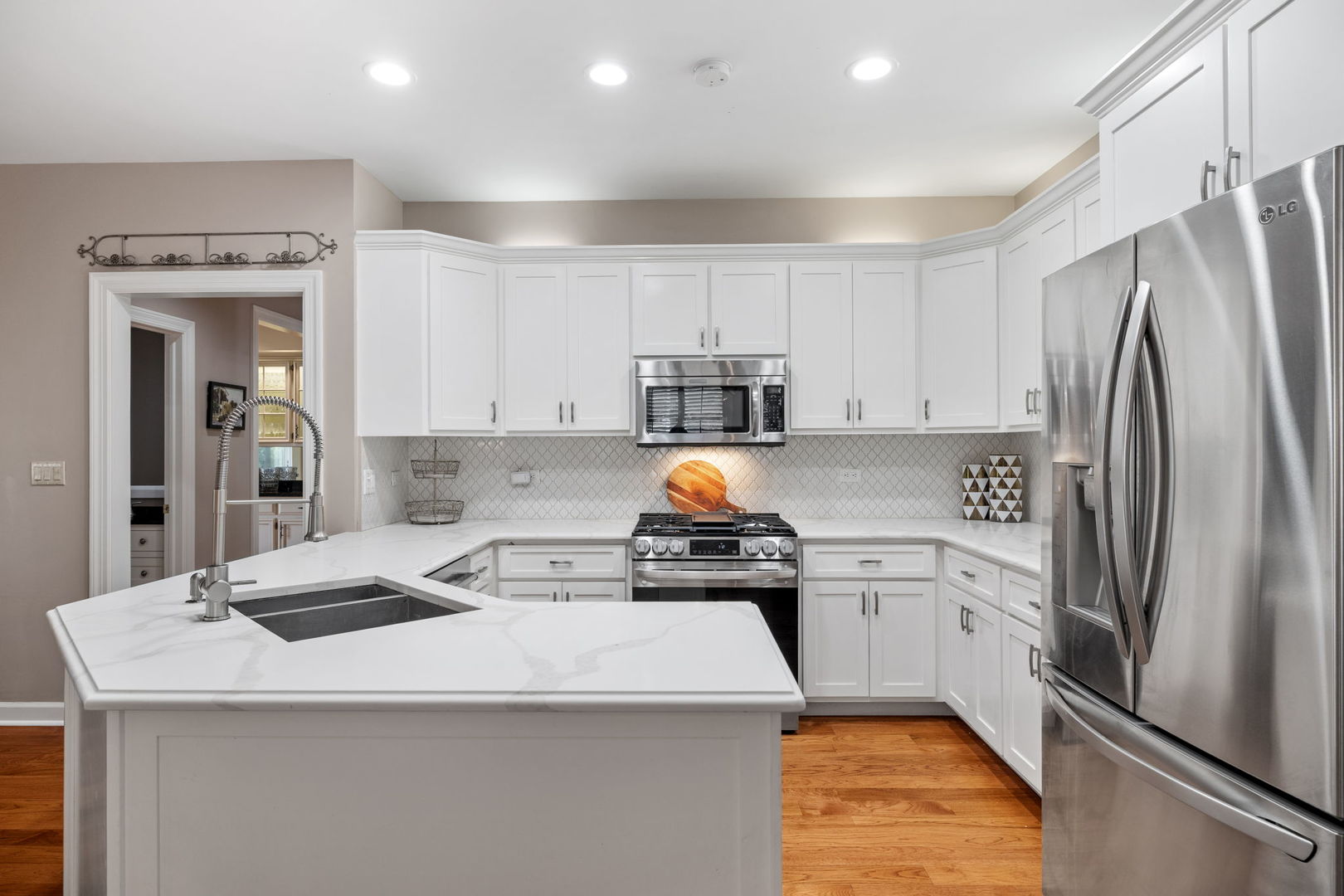55 Chesterfield Court Burr Ridge, IL 60527 - Photo 12 of 34 a kitchen with a sink a refrigerator and white cabinets