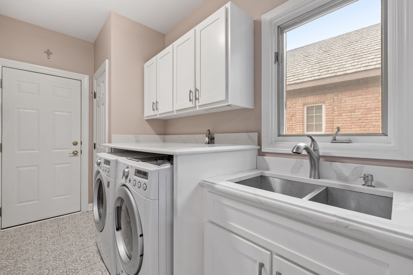 55 Chesterfield Court Burr Ridge, IL 60527 - Photo 14 of 34 a view with granite countertop a sink a washer and dryer next to a window