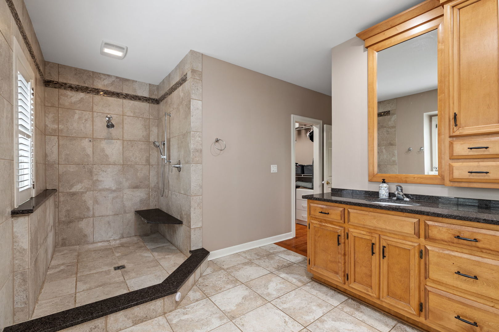 55 Chesterfield Court Burr Ridge, IL 60527 - Photo 19 of 34 a bathroom with a shower sink and mirror