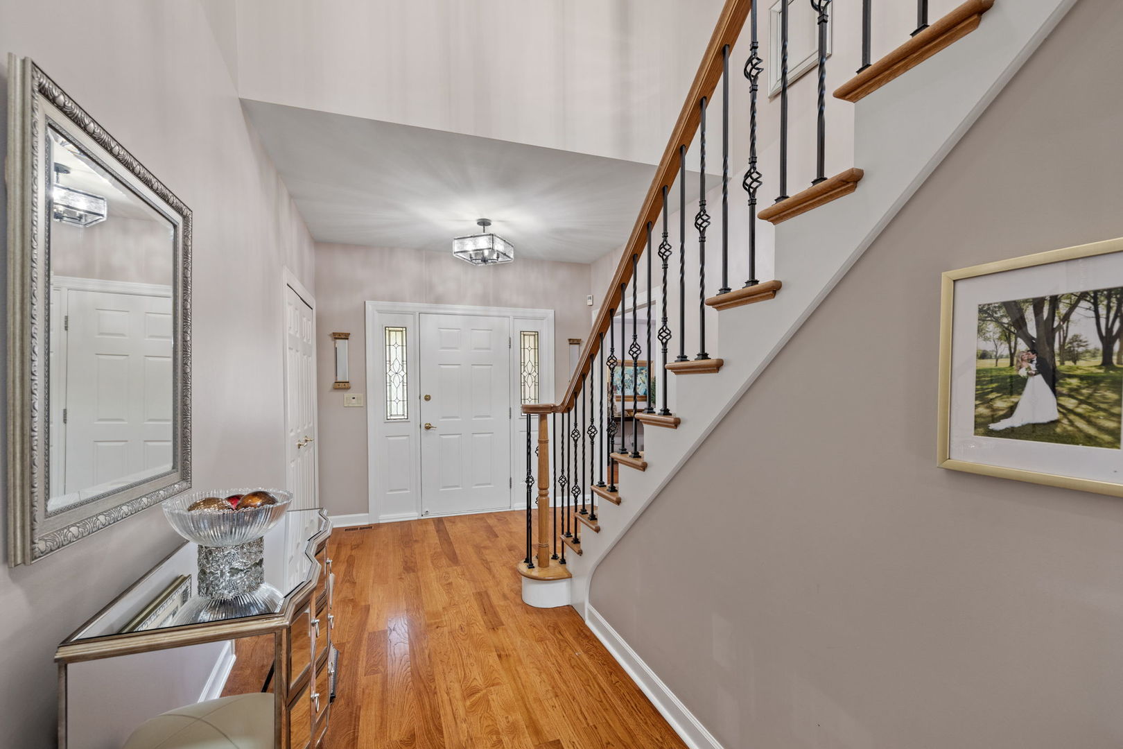 55 Chesterfield Court Burr Ridge, IL 60527 - Photo 3 of 34 a view of a hallway with wooden floor and staircase