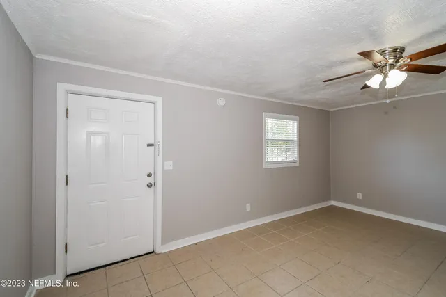 a view of an empty room and a window