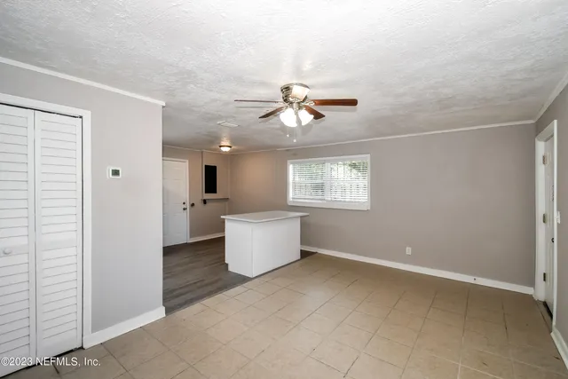 a view of a kitchen with wooden floor and a window