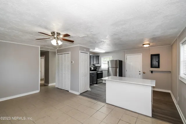 a view of living room with furniture and a ceiling fan