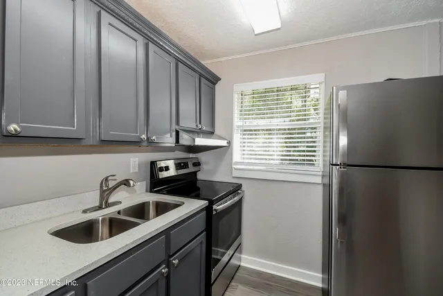 a kitchen with a refrigerator and a sink