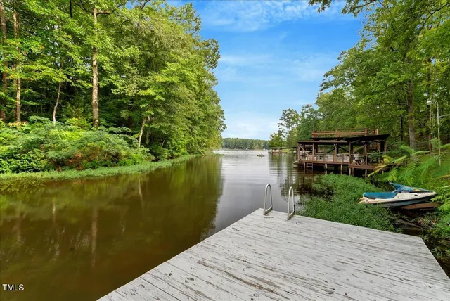 a lake view with a wooden bridge