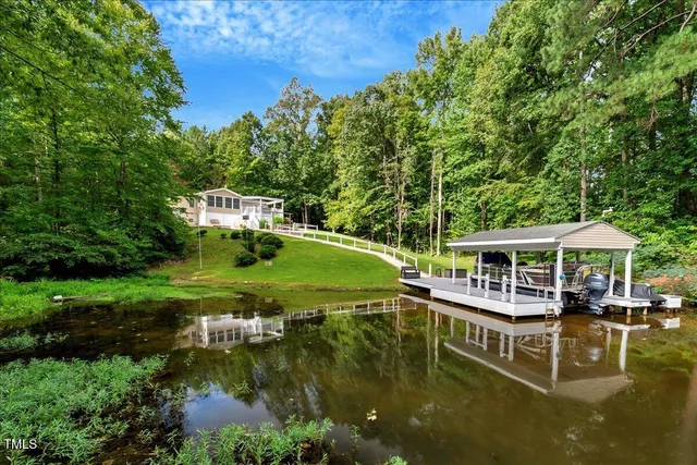 a view of a house with pool and chairs