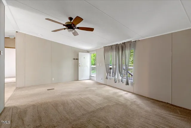 a view of a livingroom with a ceiling fan and window