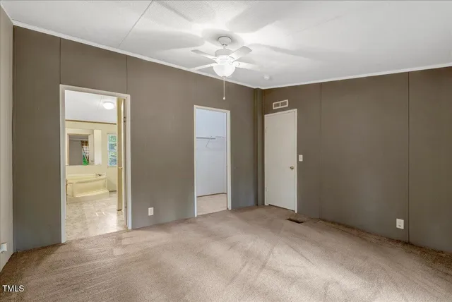 a view of an empty room with a ceiling fan