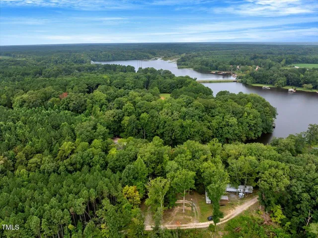 an aerial view of a city with lots of residential buildings ocean and mountain view in back