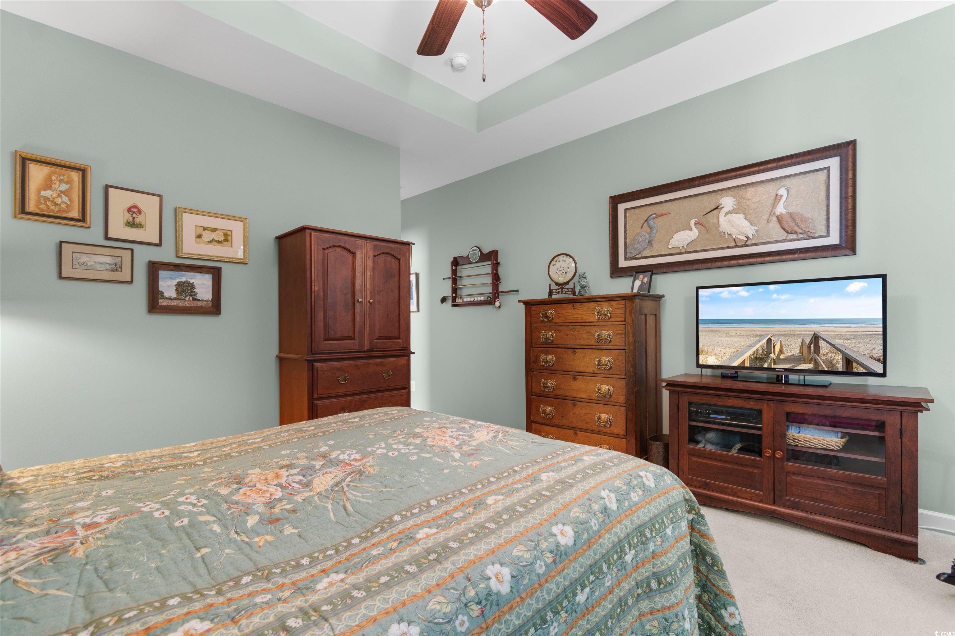 1573 Culbertson Avenue Myrtle Beach, SC 29577 - Photo 13 of 40 Bedroom with carpet floors, a ceiling fan, and a raised ceiling
